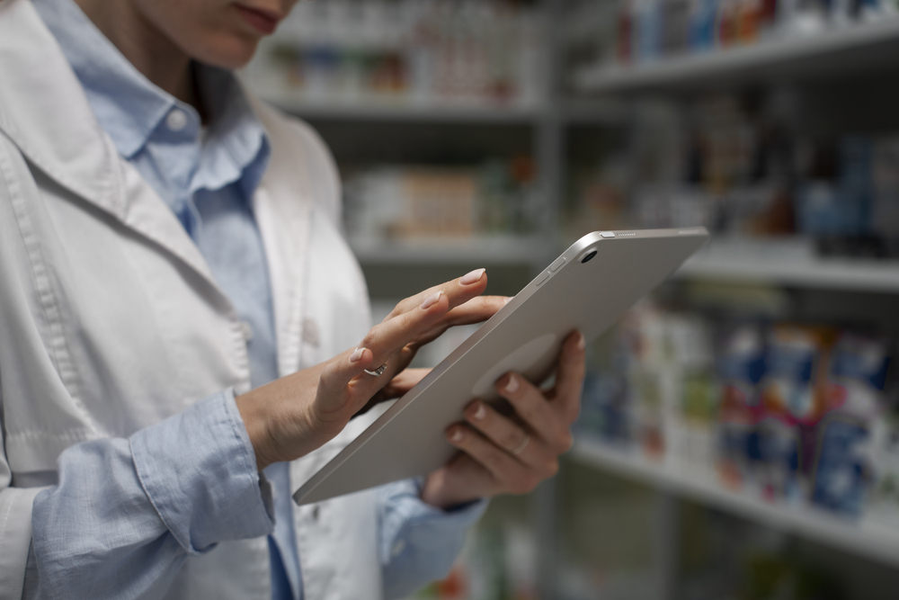 female-pharmacist-with-table-checking-stock-pharmacy (1)